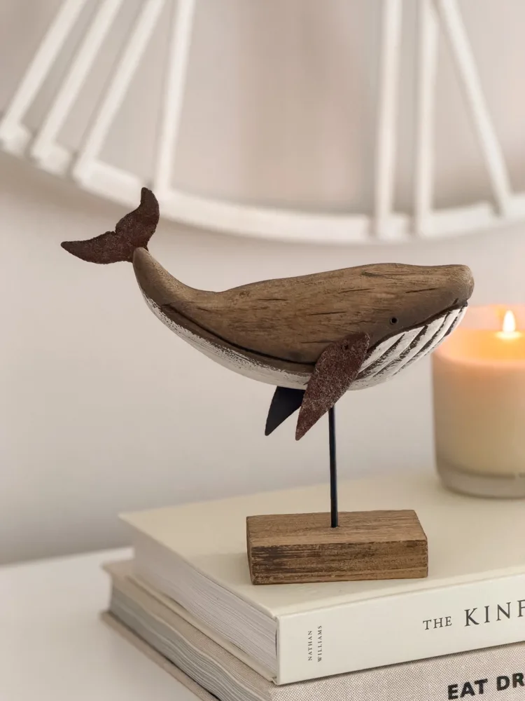 Decorative wooden whale on stand