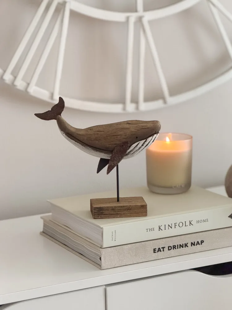 Decorative wooden whale on stand