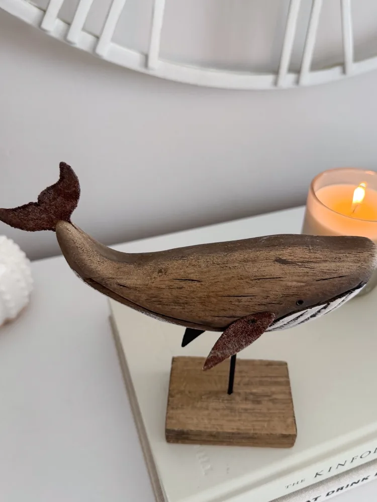 Decorative wooden whale on stand
